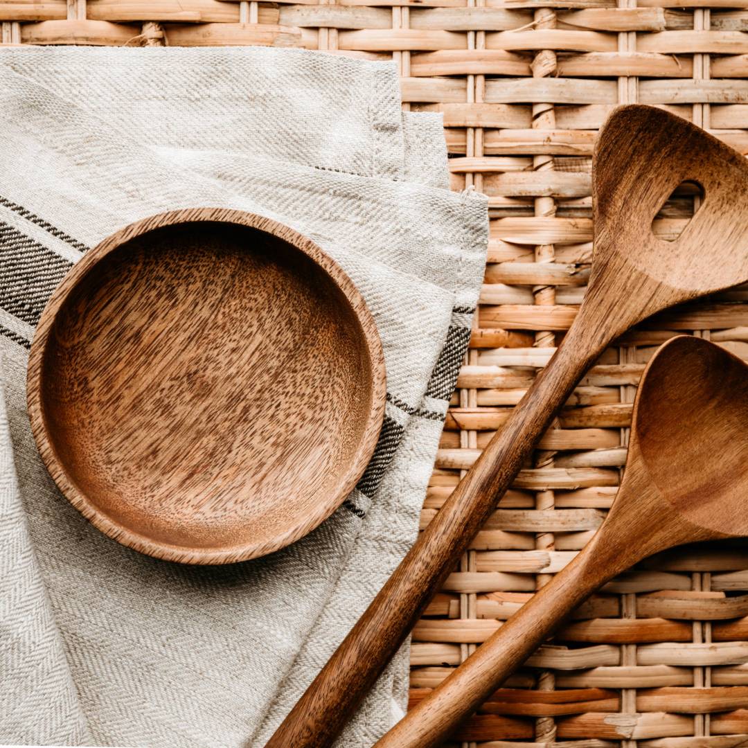 Cooking eco style background. Wooden kitchen tools and bowl on a rattan.