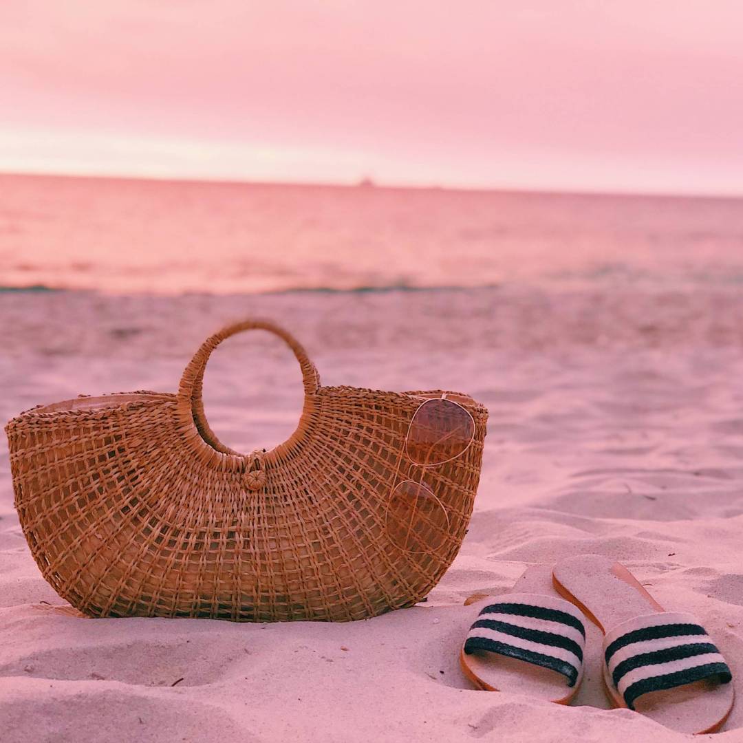 straw-bag-and-slides-at-the-beach-2022-08-01-04-50-31-utc